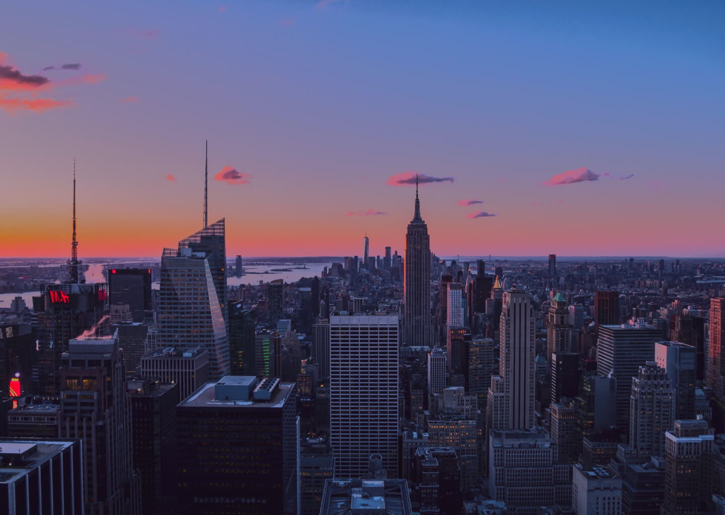 The silhouette of an iconic skyline against the canvas of a lavender twilight: New York City blog basks in the tranquil glow of dusk.