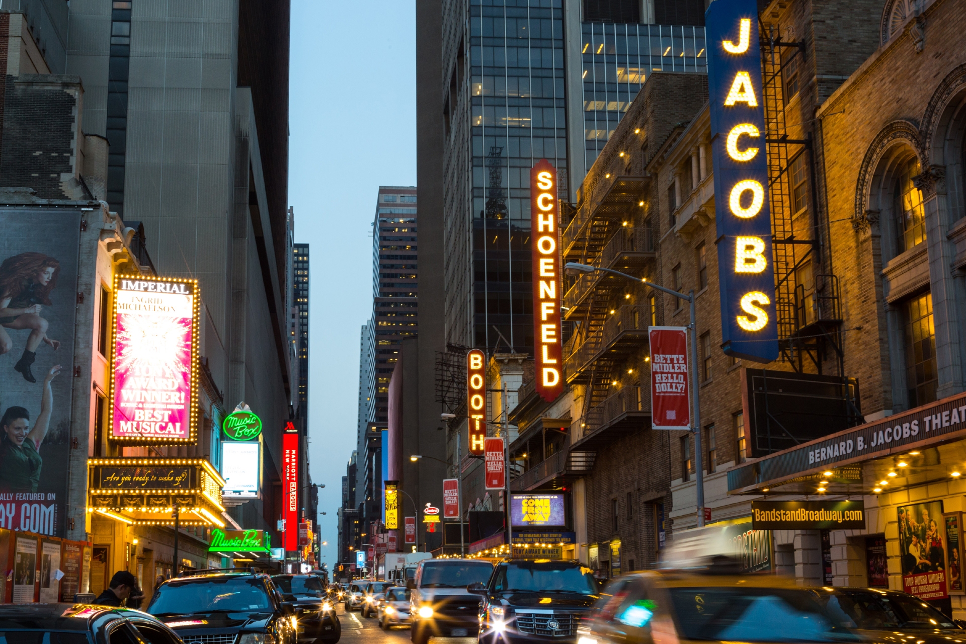 Broadway shows at night showing all the signage lit up