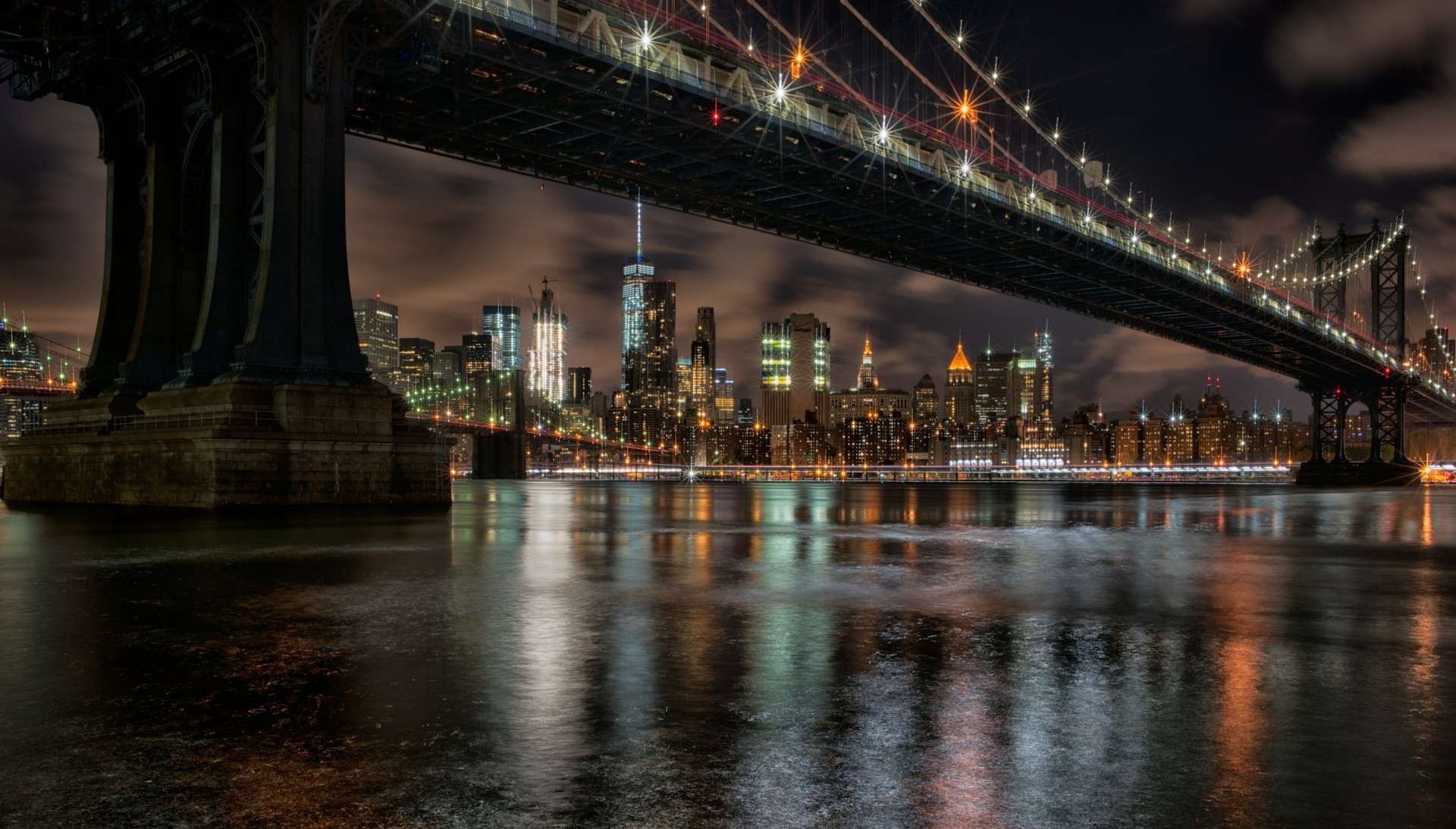 Looking up at Brooklyn Bridge at night