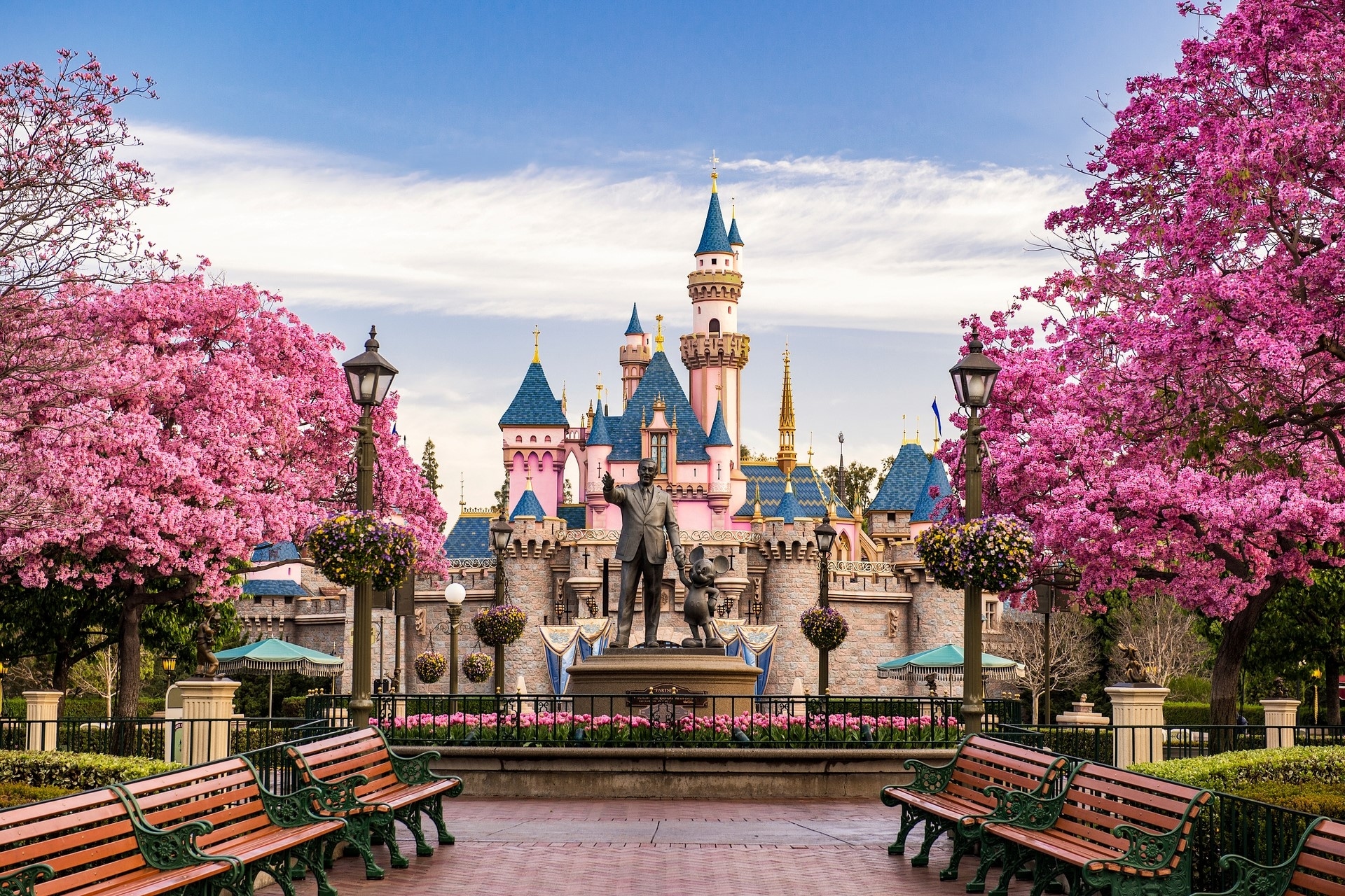 Walt Disney and Mickey Mouse statue in front of Fantasyland Castle in Disneyland California
