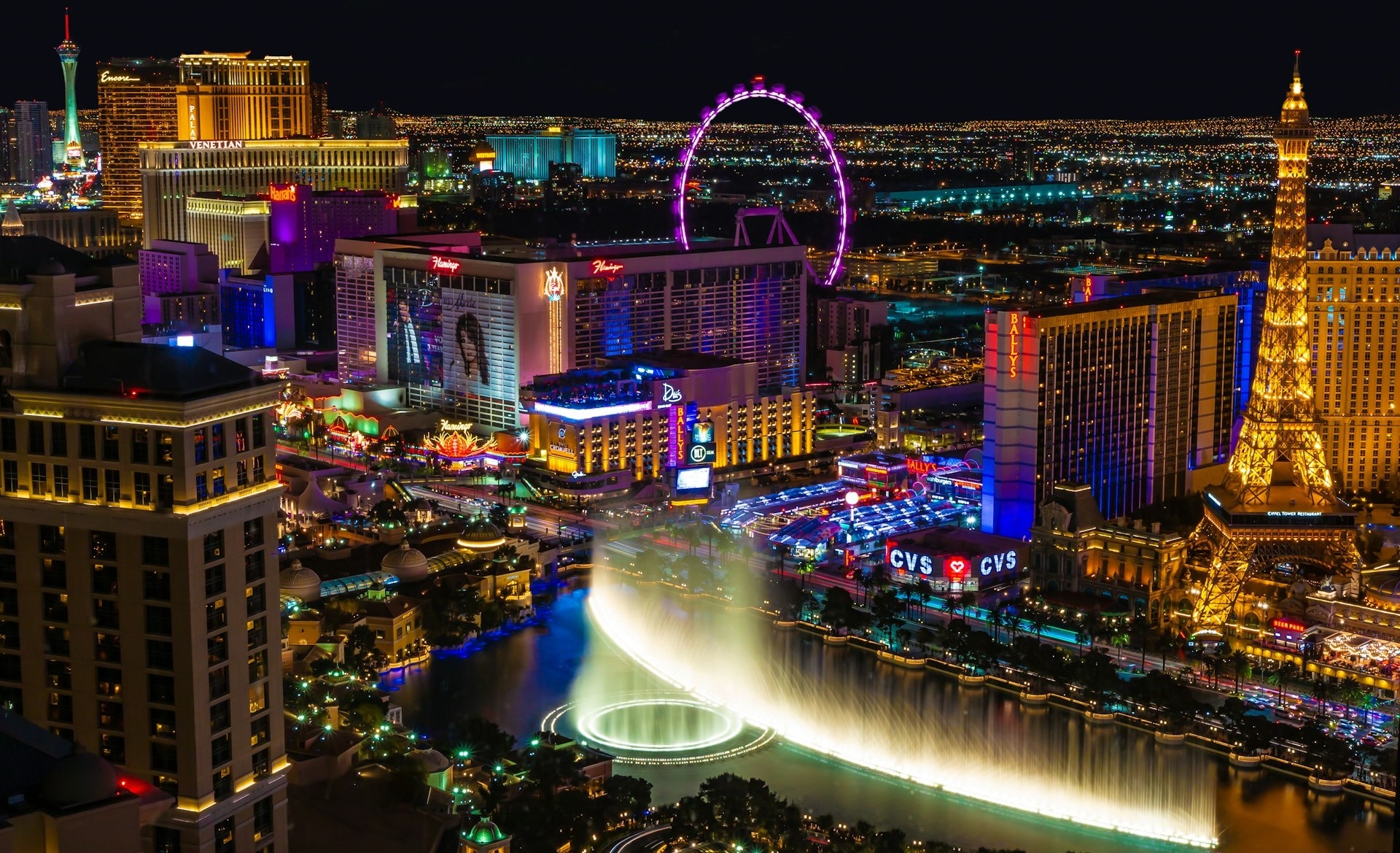 Las Vegas Strip with city lights & view of Bellagio fountain