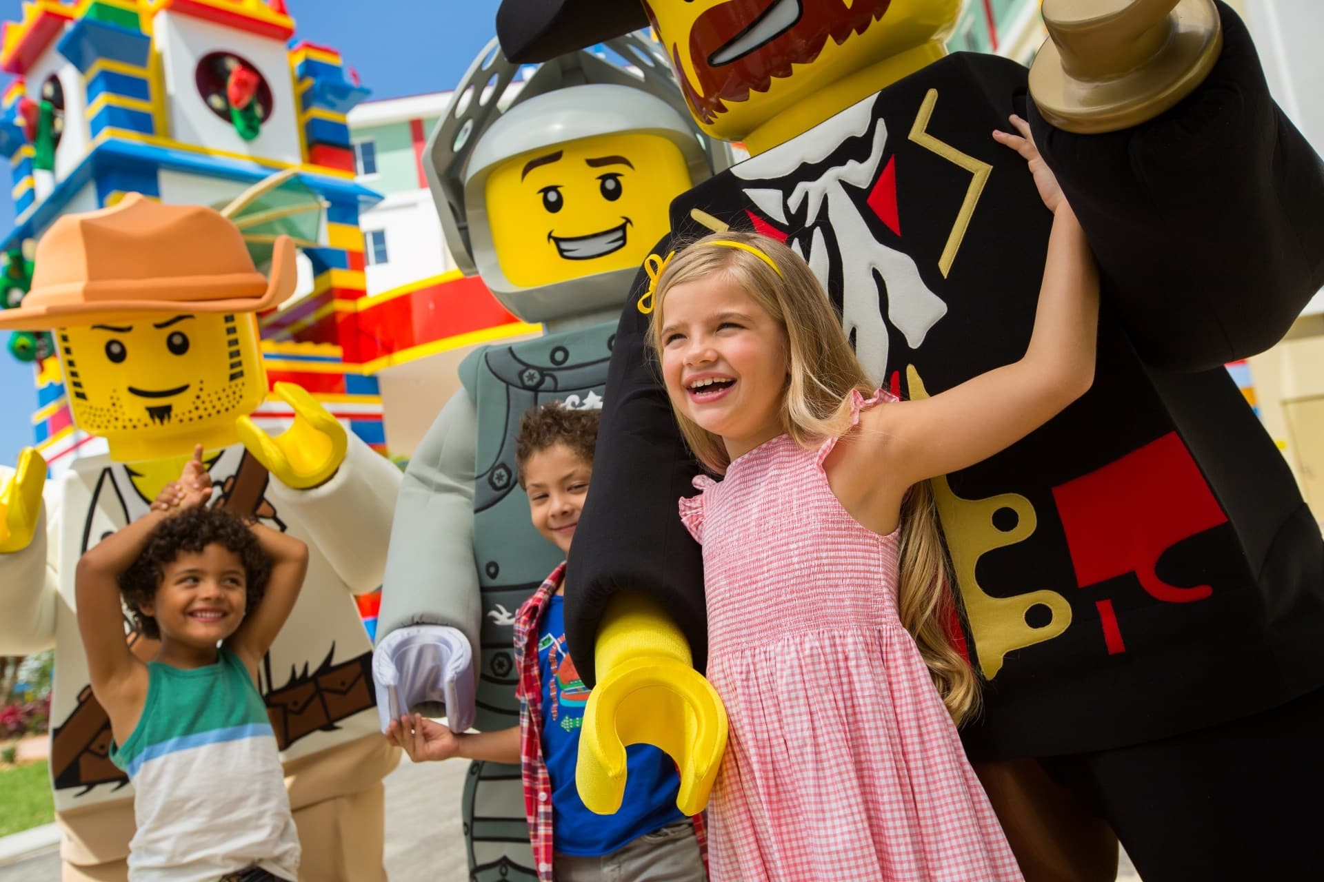 Children smiling with LEGOLAND characters, California