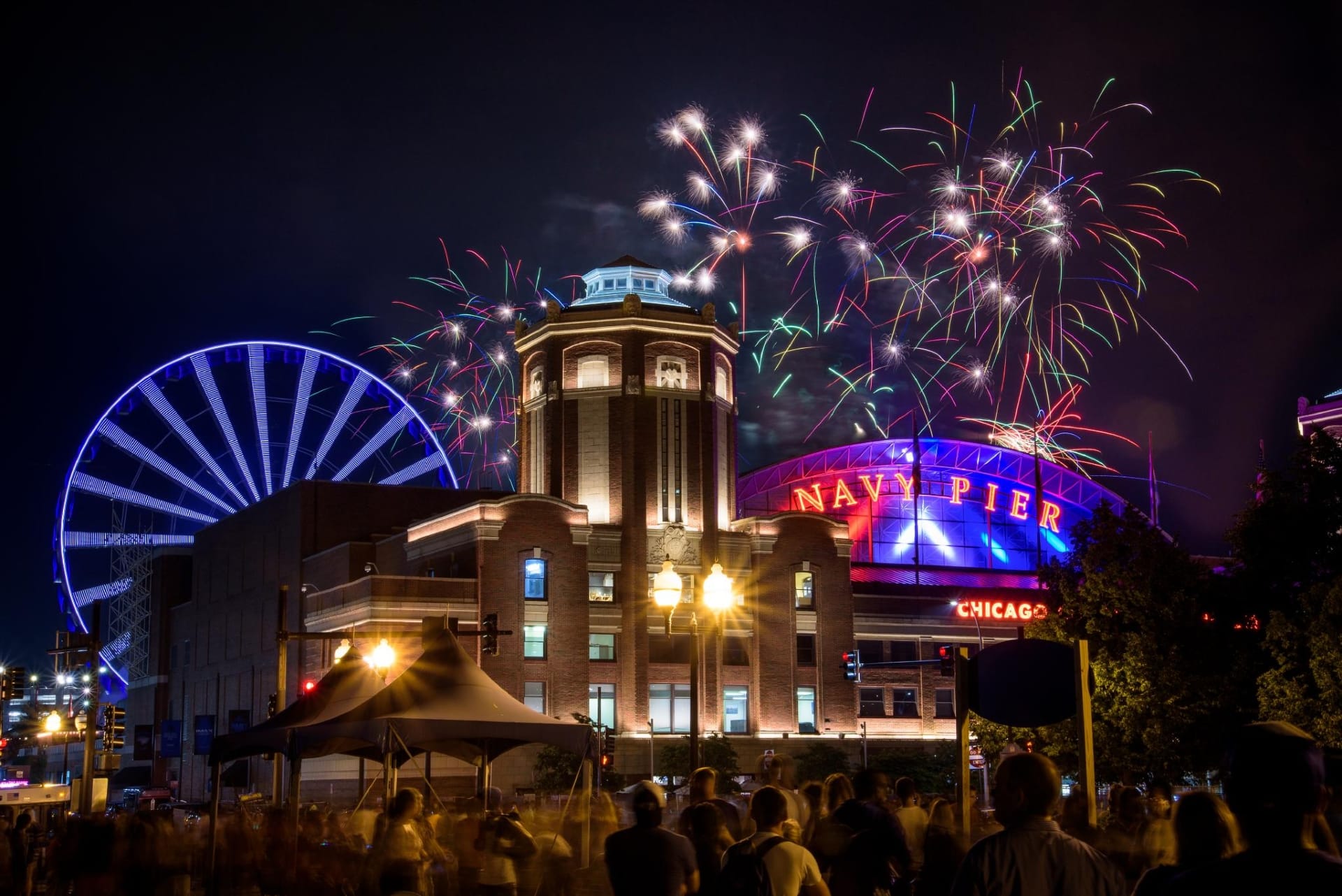 Navy Pier at night with Ferris wheel & fireworks in the background