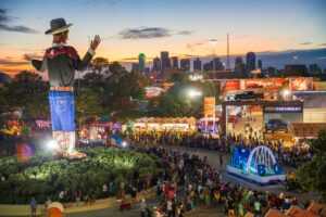 State Fair of Texas crowd at sunset with view of Big Tex