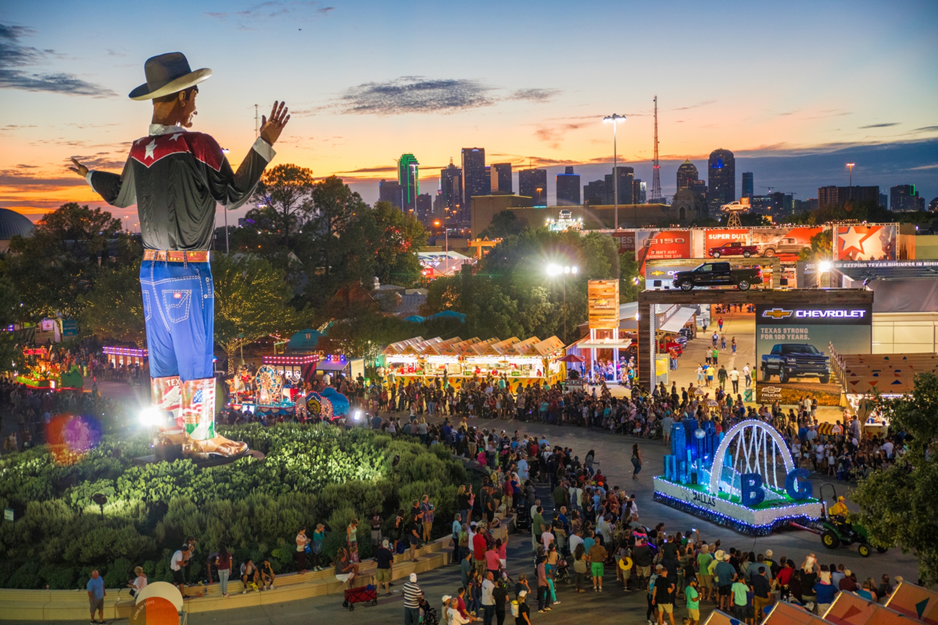 State Fair of Texas crowd at sunset with view of Big Tex