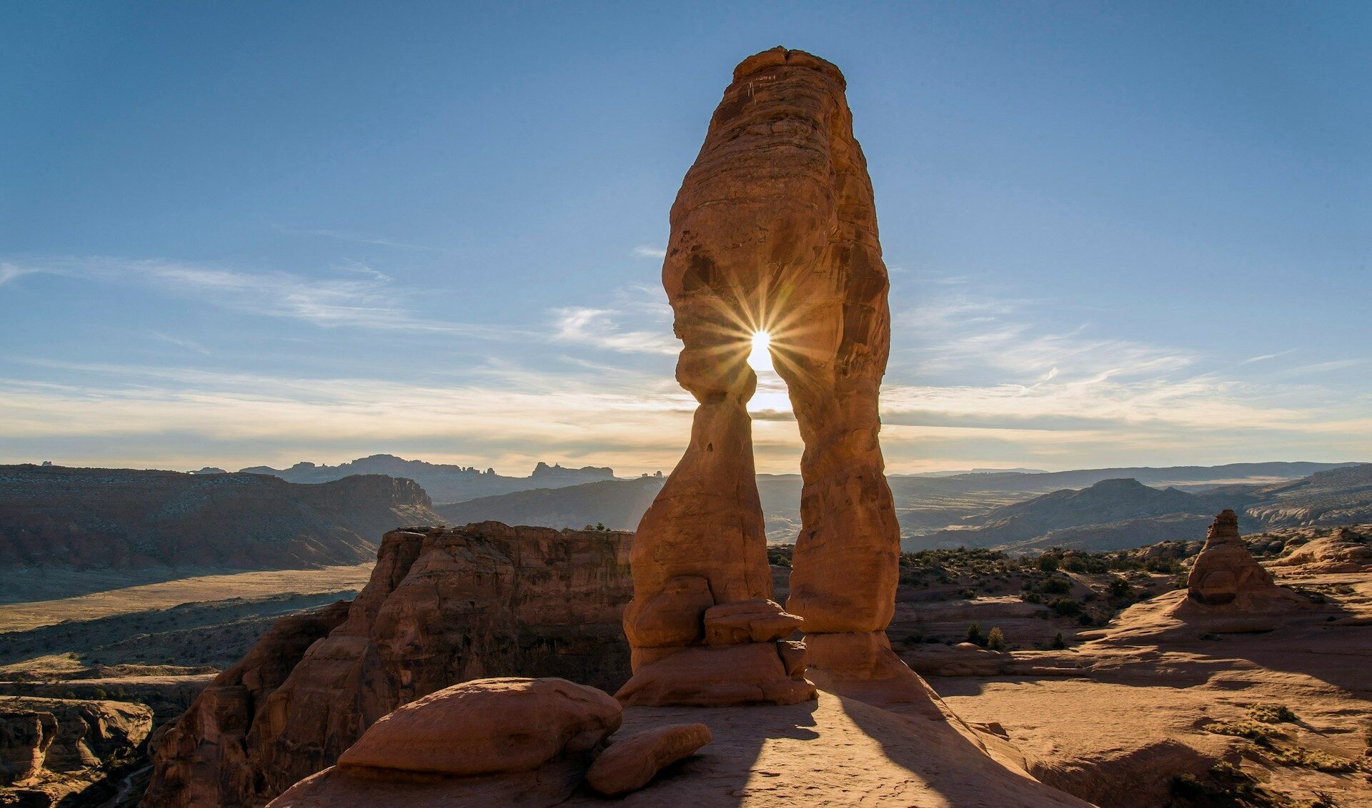 Arches National Park stunning sunny day with the sun shining through the arch