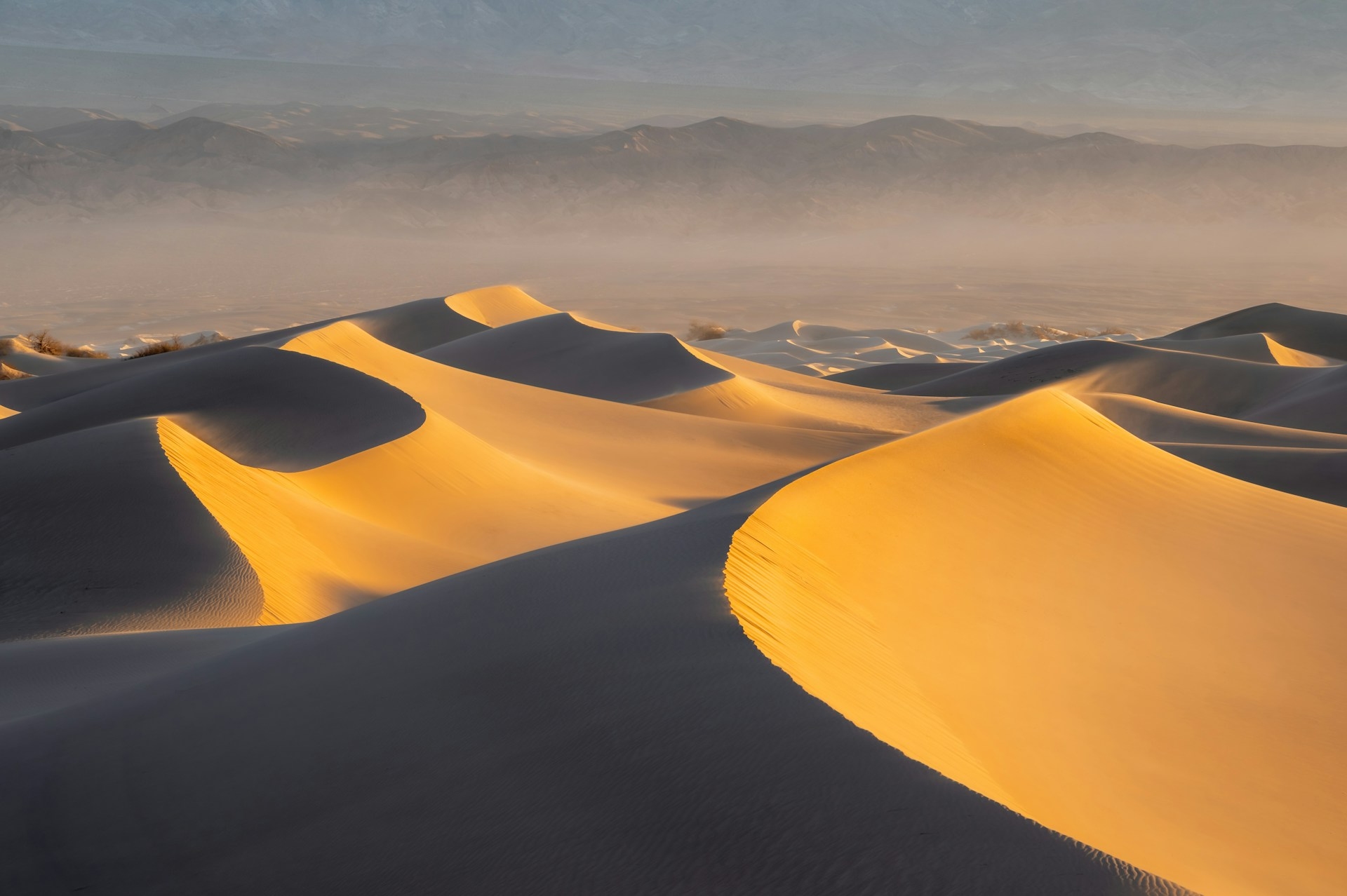 Death Valley National Park in California with stunning shot of sun falling on the dunes