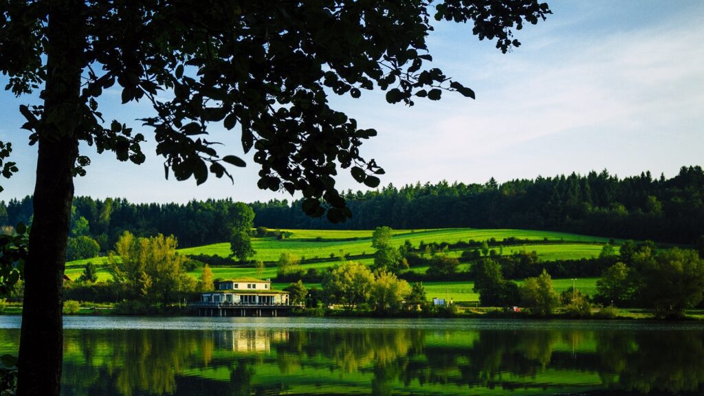 Finger Lakes WA stunning view of rolling green hills & still lake