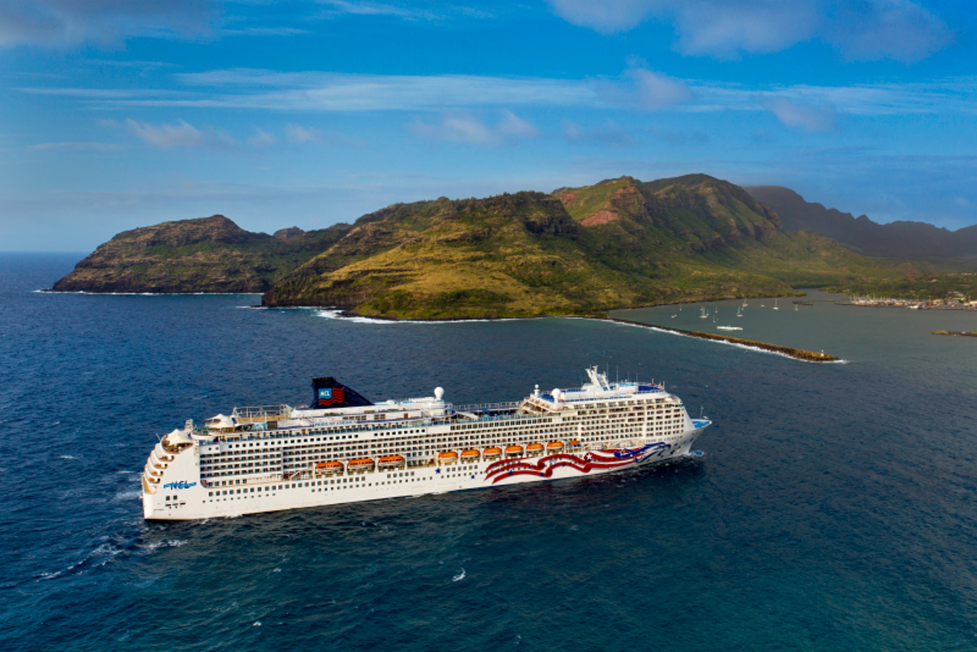 A majestic cruise ship sets sail on a serene blue ocean, with lush green tropical islands providing a picturesque backdrop for the cruising voyage.
