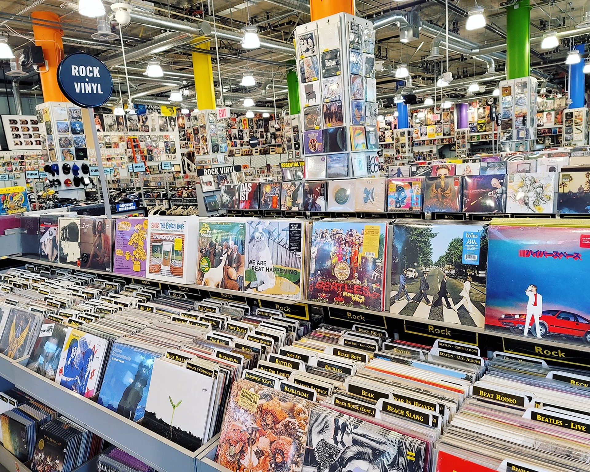 A vibrant and diverse selection of rock vinyl records and music albums on display in a Los Angeles music store, inviting customers to discover classic hits and explore new tunes.