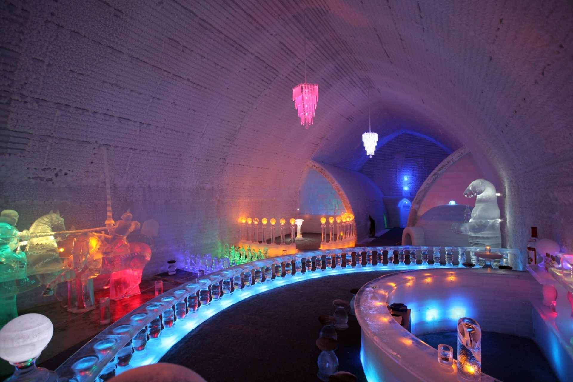 An enchanting ice bar bathed in a kaleidoscope of neon lights, showcasing a unique fusion of ice-sculpted decor and chilled ambiance.