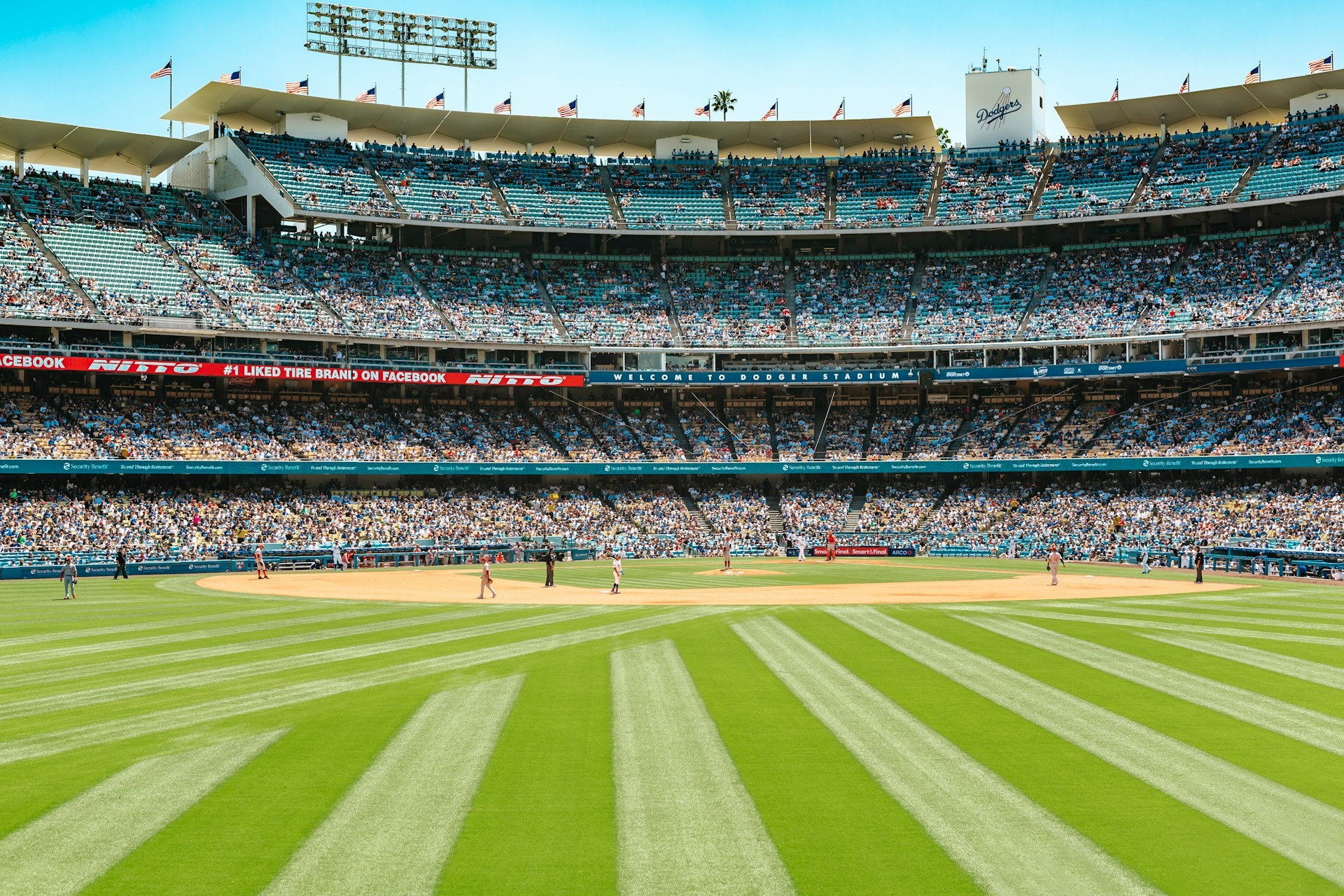 A sunny day at the ballpark in Los Angeles with a crowd eagerly watching a baseball game in progress.