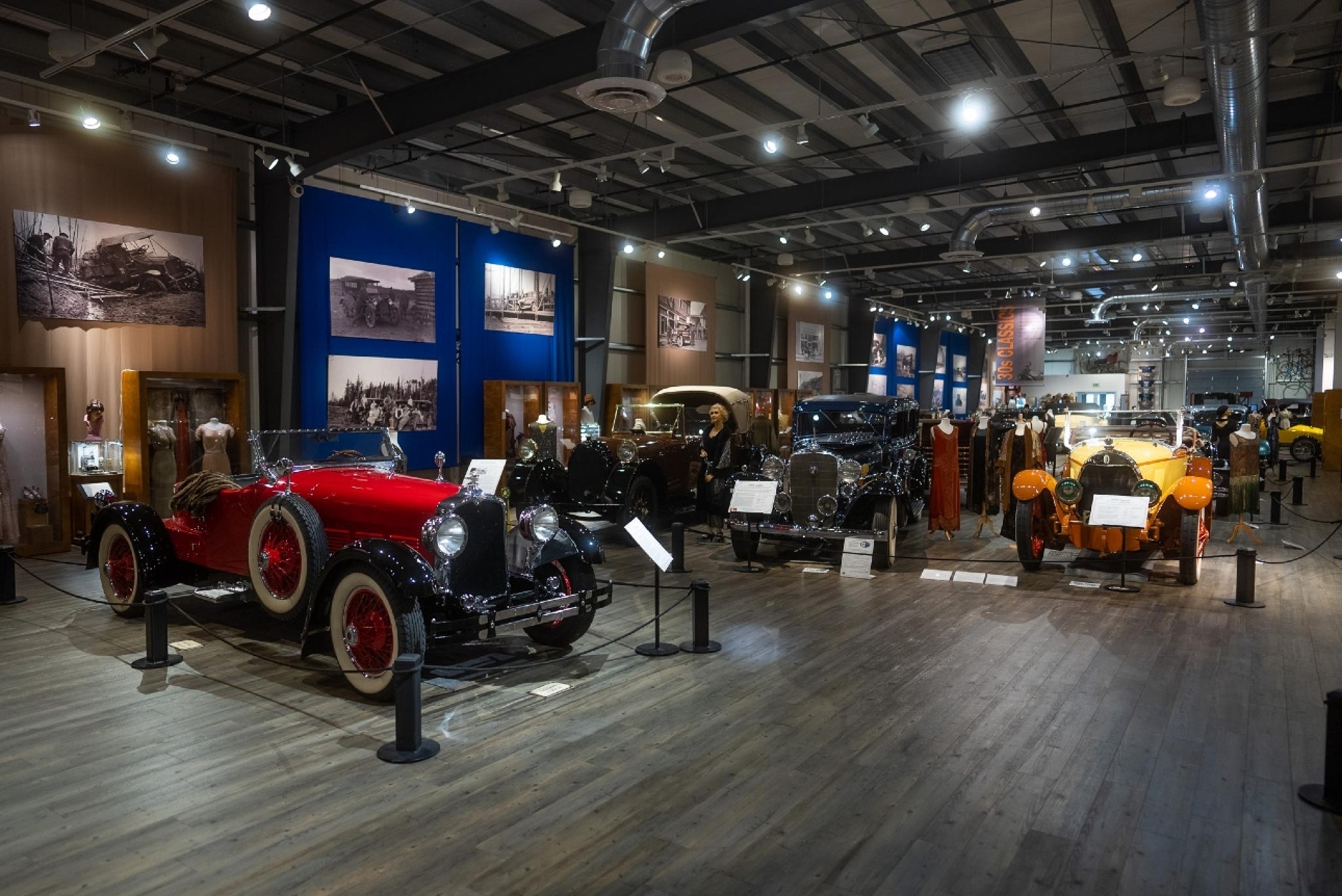Classic cars on display in a vintage automobile museum exhibit, showcasing the elegance and history of early automotive design.