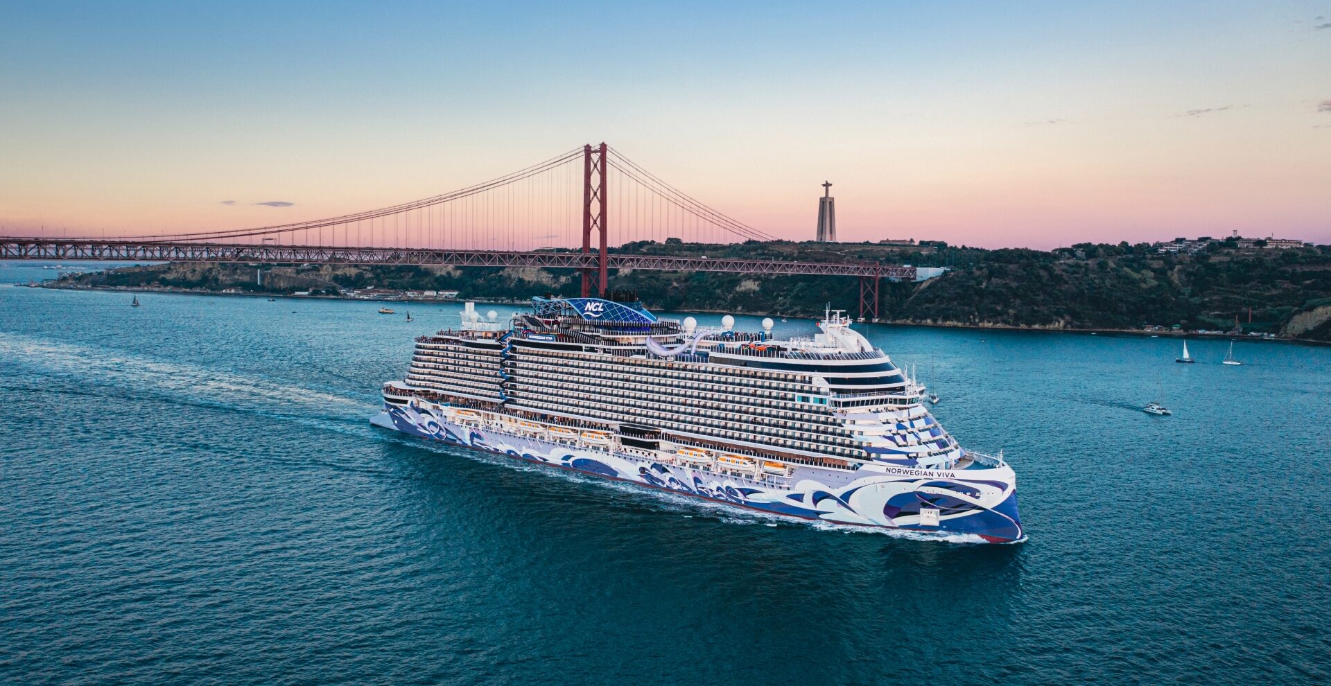 A modern cruise ship gracefully sails under a majestic suspension bridge, with a historic lighthouse standing sentinel on the coastline, as the azure sky fades into the warm hues of sunset.
