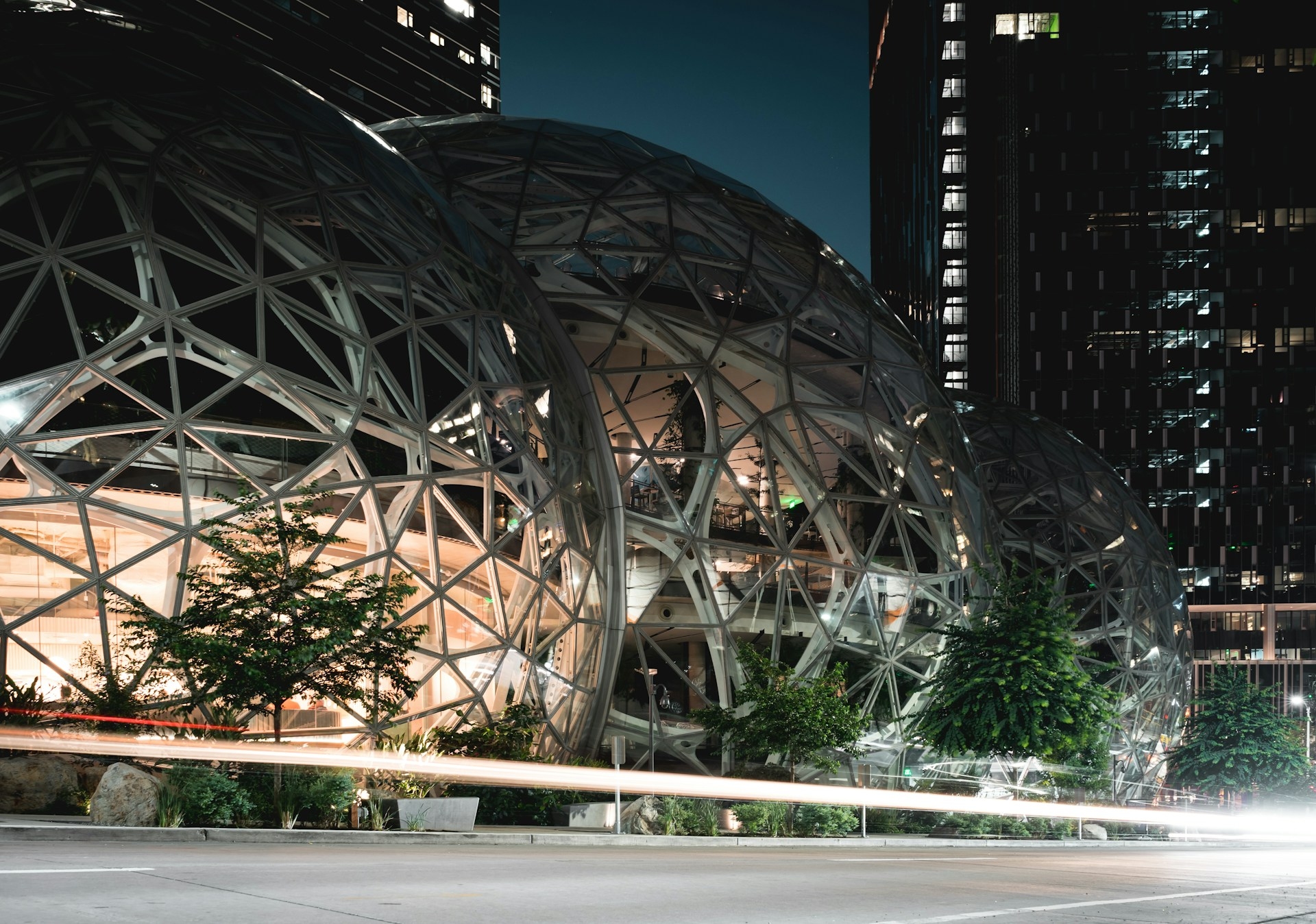Geometric marvel: illuminated spheres amidst urban nightlife.