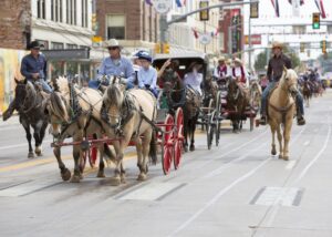 Cheyenne Frontier Days Parade - Laramie County Festivals & Events of Wyoming showing the horse & carts going down the main street