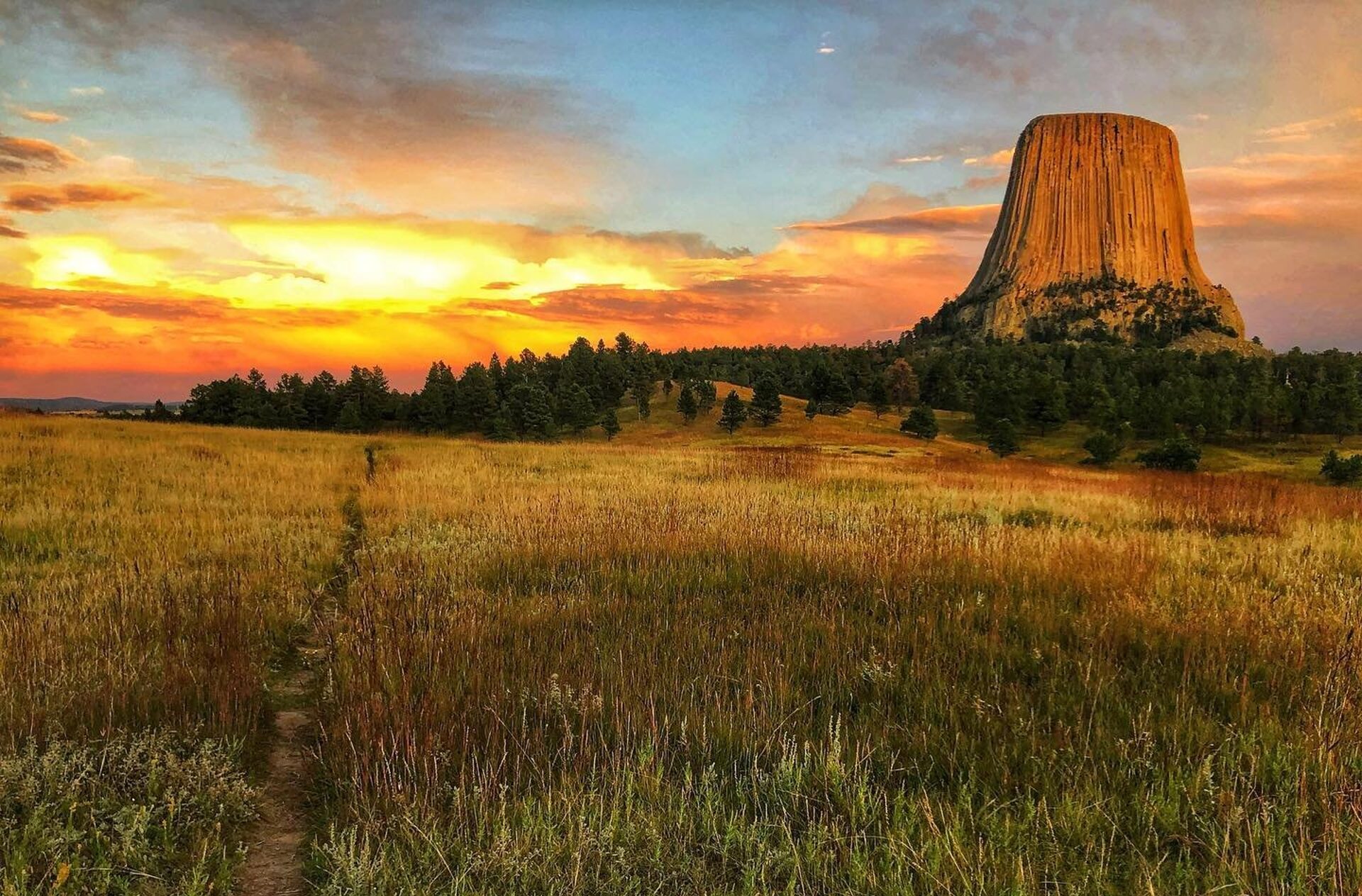 Devils Tower National Monument at sunset showing the path to the monument