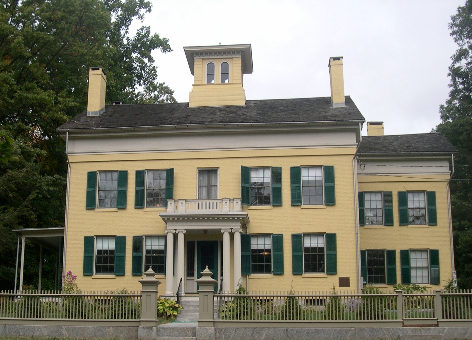 Emily Dickinson Museum showing the outside view of the museum painted in yellow & green