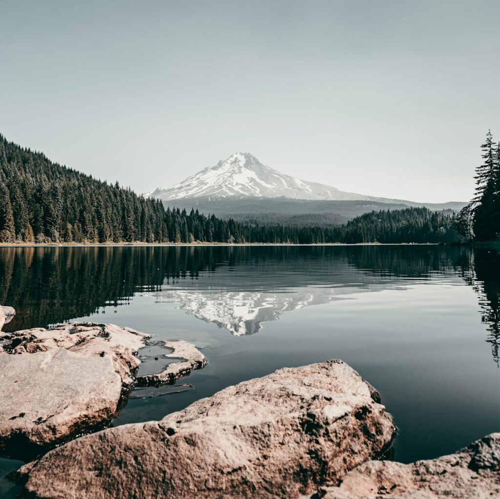 Mt Hood Oregon stunning image of rocks in the foreground & the mountain reflection in the water