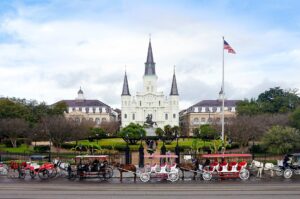 New Orleans City Shot of the park horses & carts & church in the background