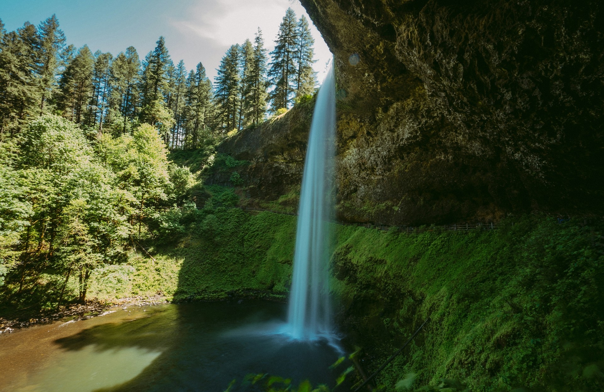 Silver Falls Oregon on a clear sunny day looking from the under side of the waterfall