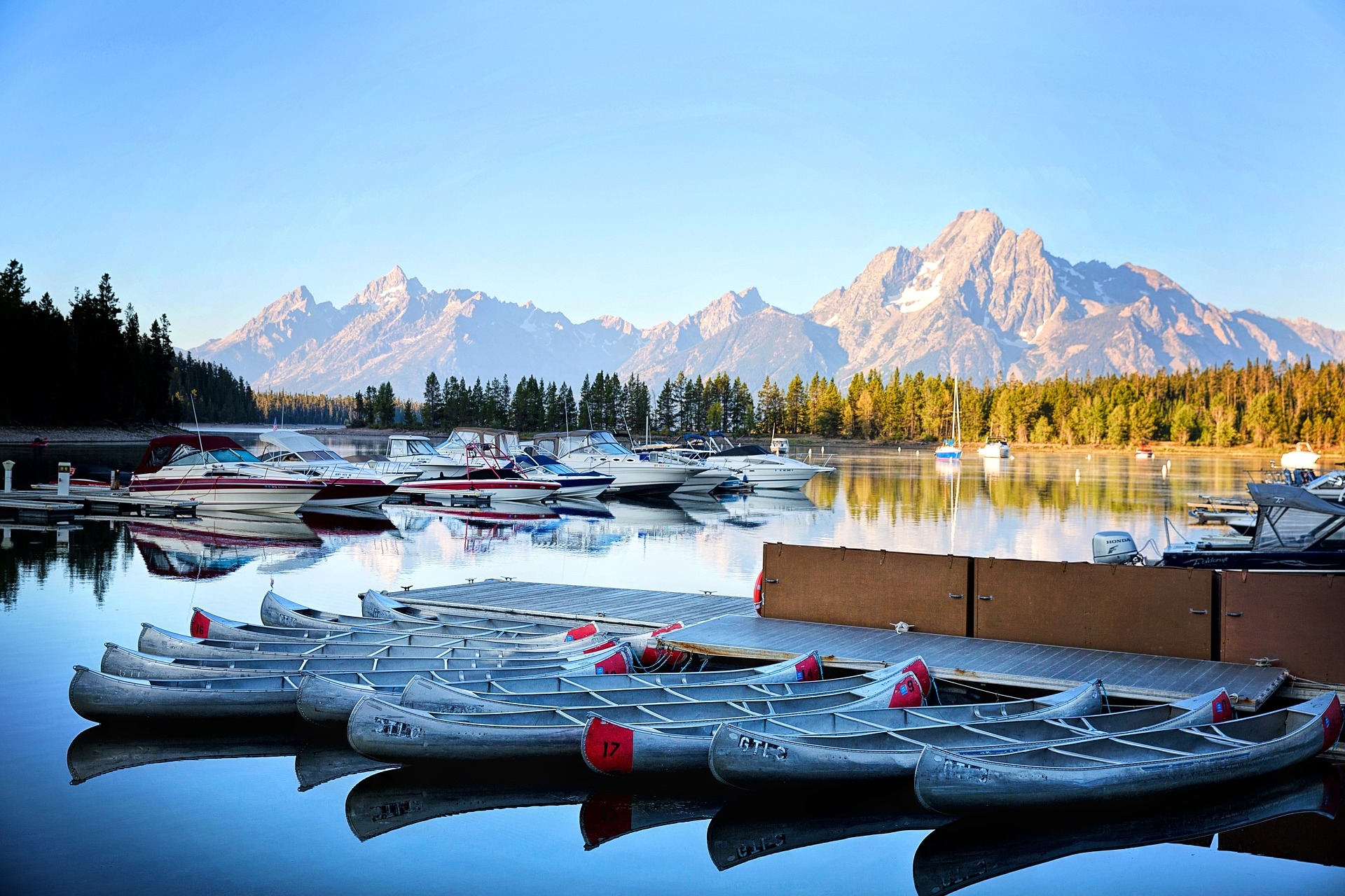 Wyoming Grand Tetons on a sunny summer day with the kayaks and speed boats ready to go out on the lake for a days adventure