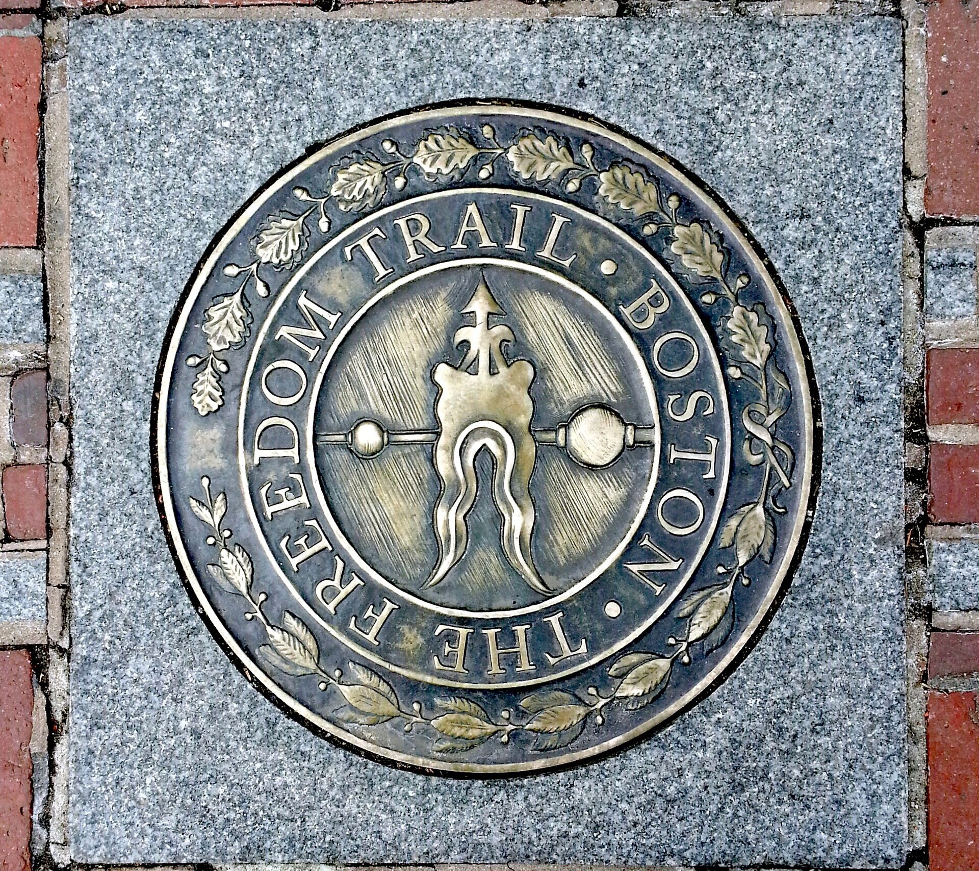 freedom-trail in Boston Massachusetts with the metal emblem embedding into the brick path
