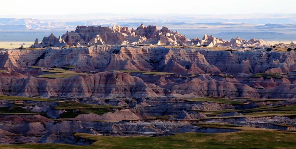 Badlands-at-sunset South Dakota with the stunning rock formations and layers of colours