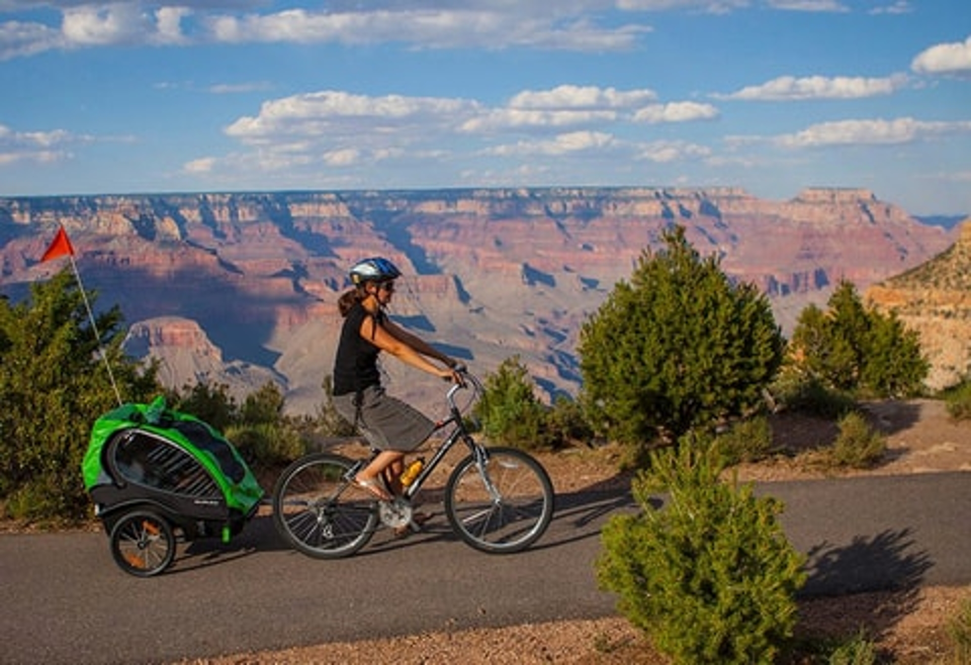 Grand_Canyon biking is a great way to get around the canyon shown with a child caddy behind the bike