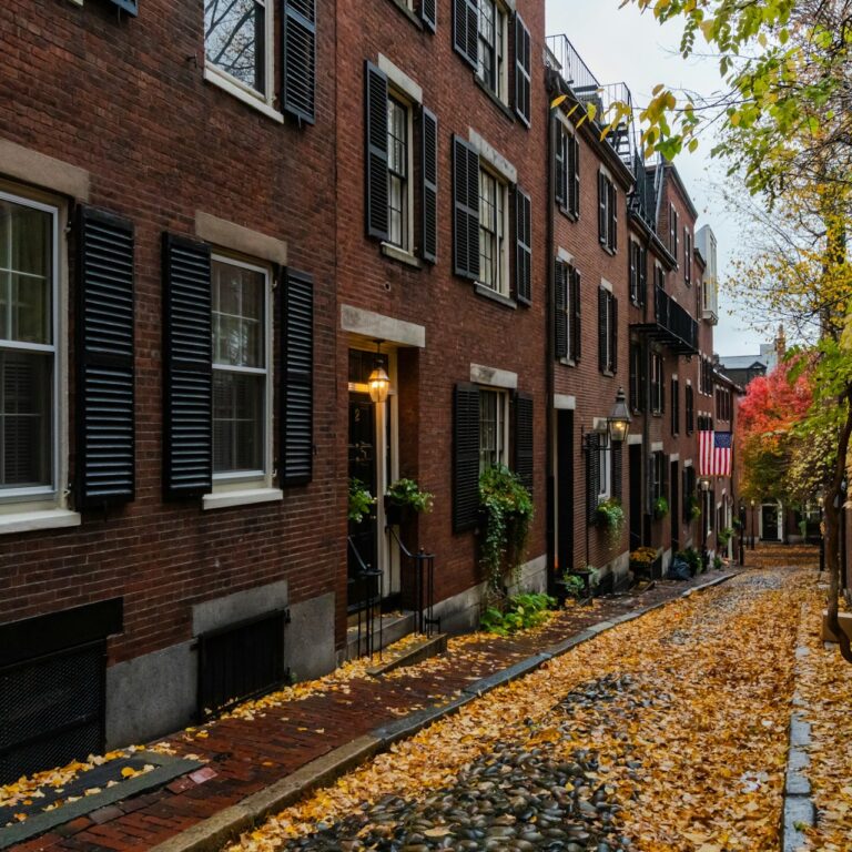 Boston historic Acorn Street most famous street in Boston with the cobble stone street with the yellow leaves covering the road
