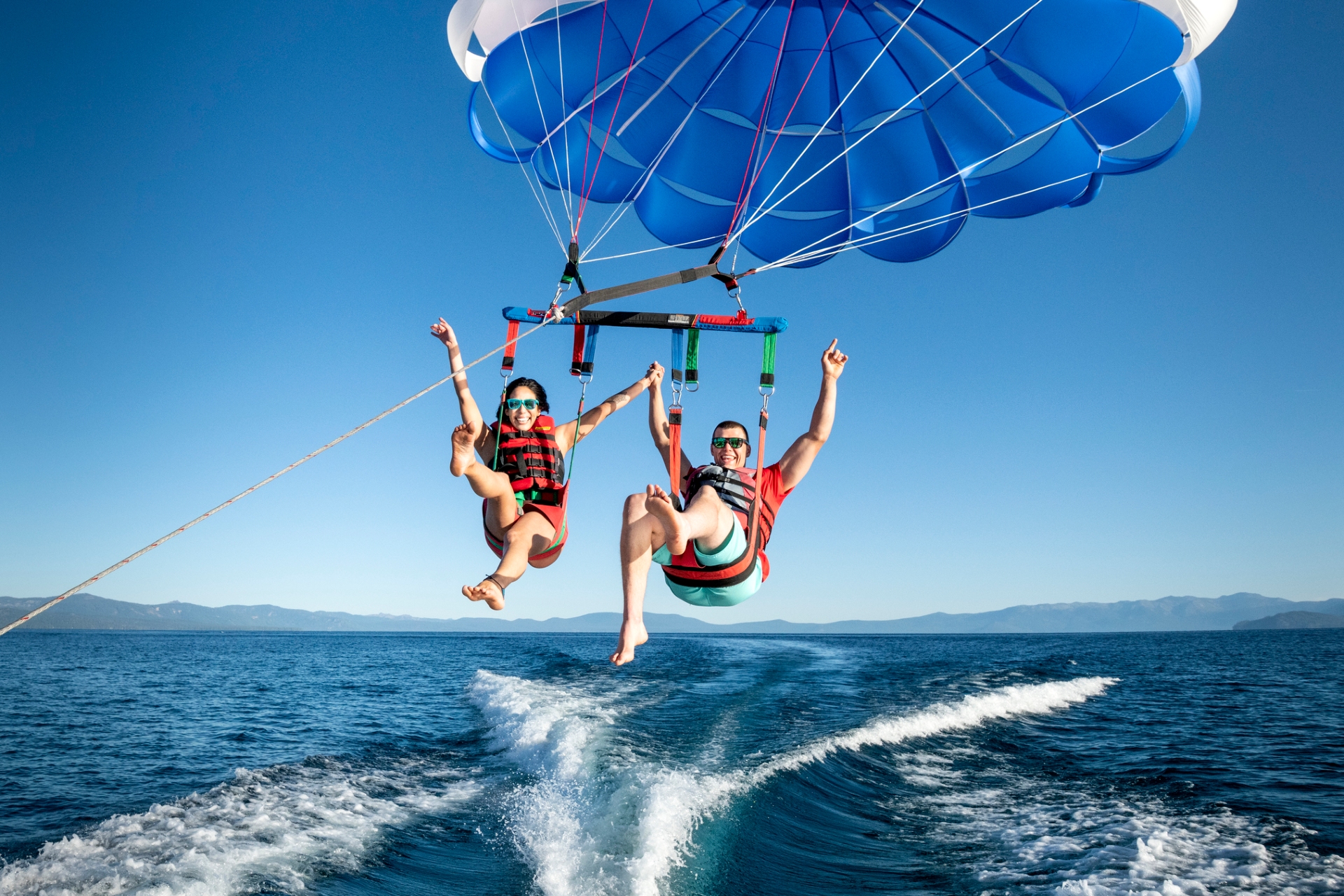 Couple parasailing over Lake Tahoe Credit Rachid Dahnoun and Lake Tahoe Visitors Authority