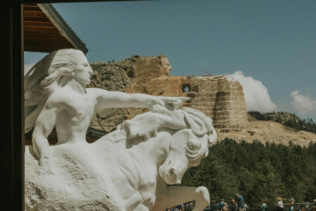 Crazy Horse Memorial South Dakota showing the statue & the replica that is still being created in stone in the distance