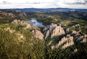 Custer State Park South Dakota with the lake in middle and stunning rock formations in the foreground