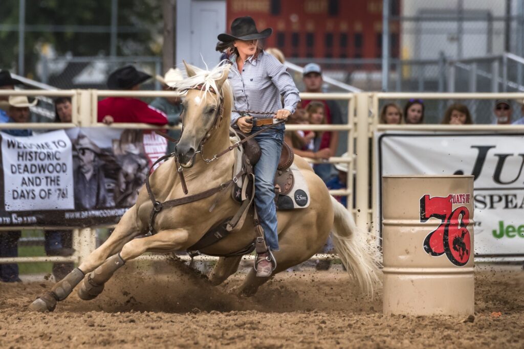 Days of 76 Deadwood festival held every year showing the horse event with a women cowgirl