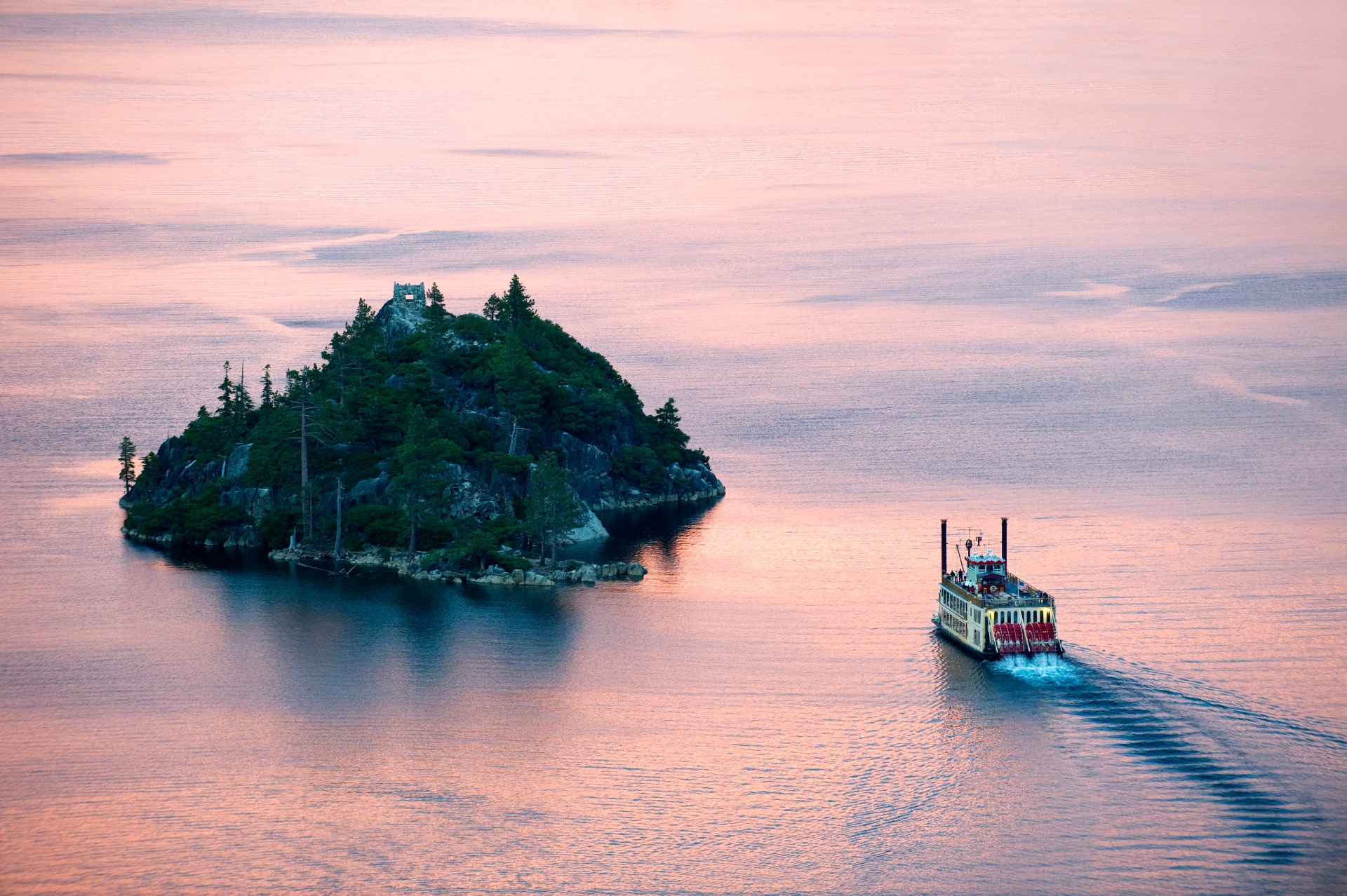 Emerald Bay at sunset and the M.S. Dixie paddling by Fannette Island Credit Aramark Richard Dahnoun and Lake Tahoe Visitors Authority