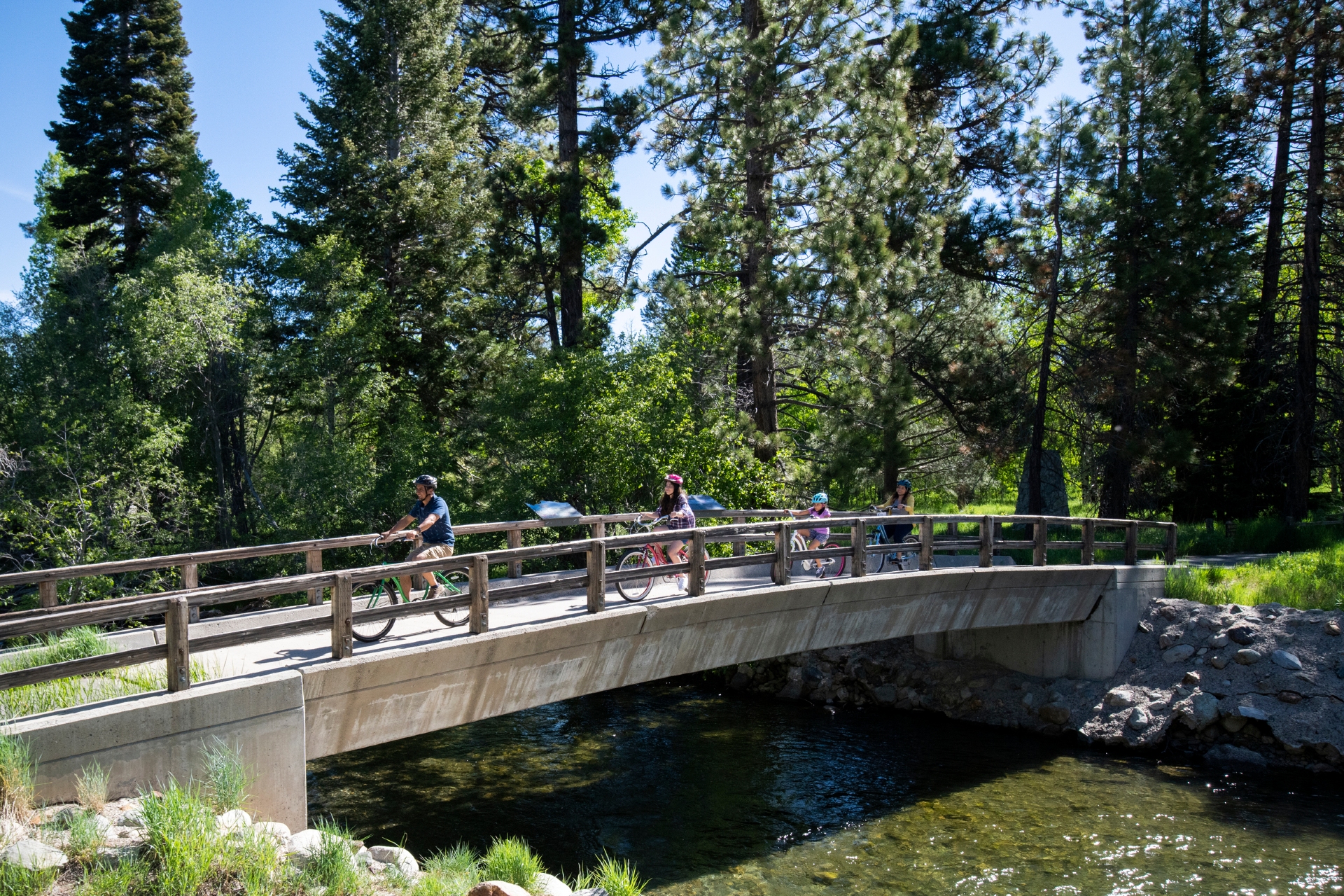 Family riding bikes over a bridge in South Lake tahoe Credit Rachid Dahnoun and Lake Tahoe Visitors Authority 1