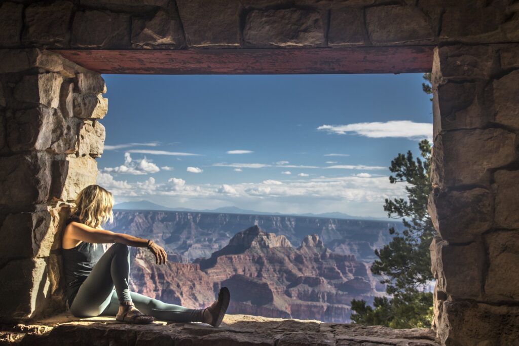 Grand-Canyon looking through a stone lookout viewing platform