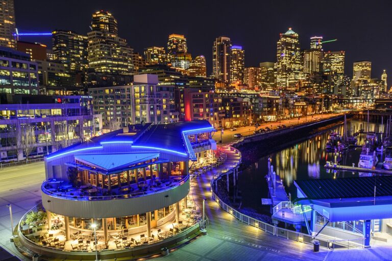 Seattle waterfront at night with the night lights reflecting in the water in Washington State