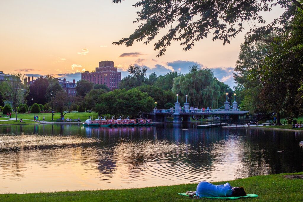 Boston Downtown Public Garden Common showing the swan boats docked close to the main bridge of the park