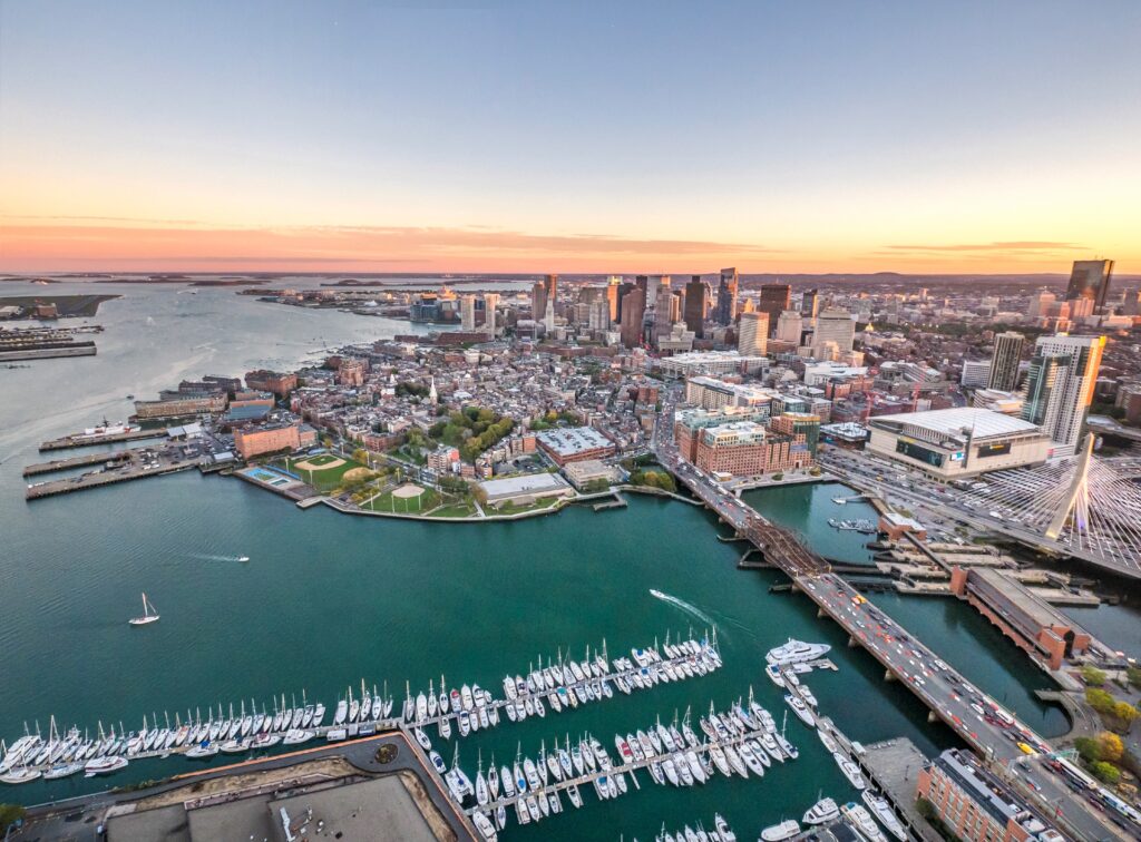 Boston Harbour on a clear day showing the sunset in the distance with the deep blue waters of the habour