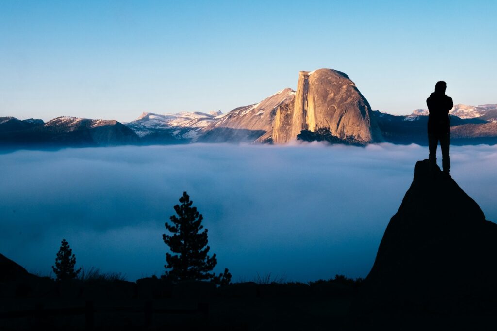 Yosemite foggy evening with the half dome peaking through CA Image By john gibbons unsplash