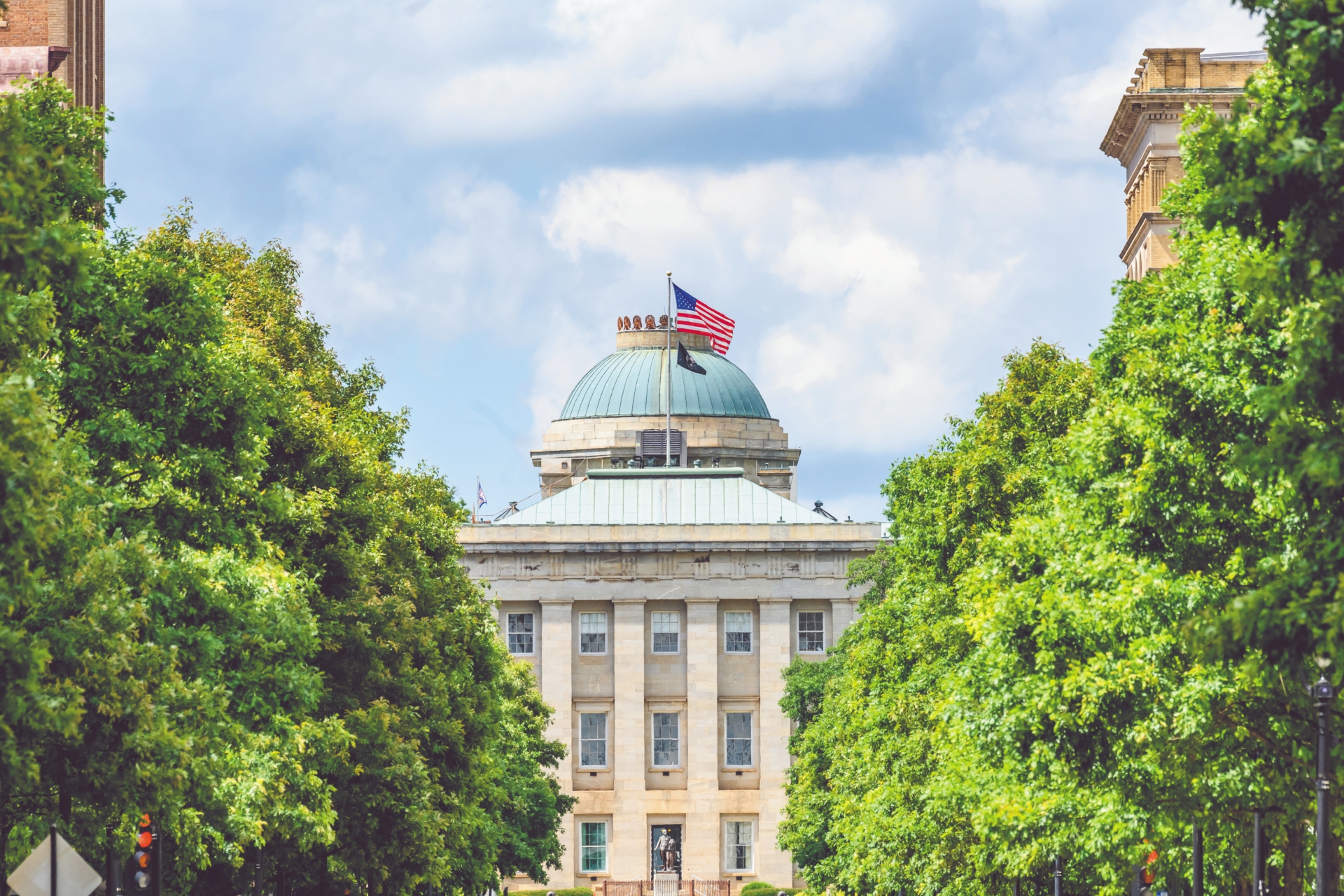 North Carolina State Capitol Building Framed By Trees Credit VisitNC