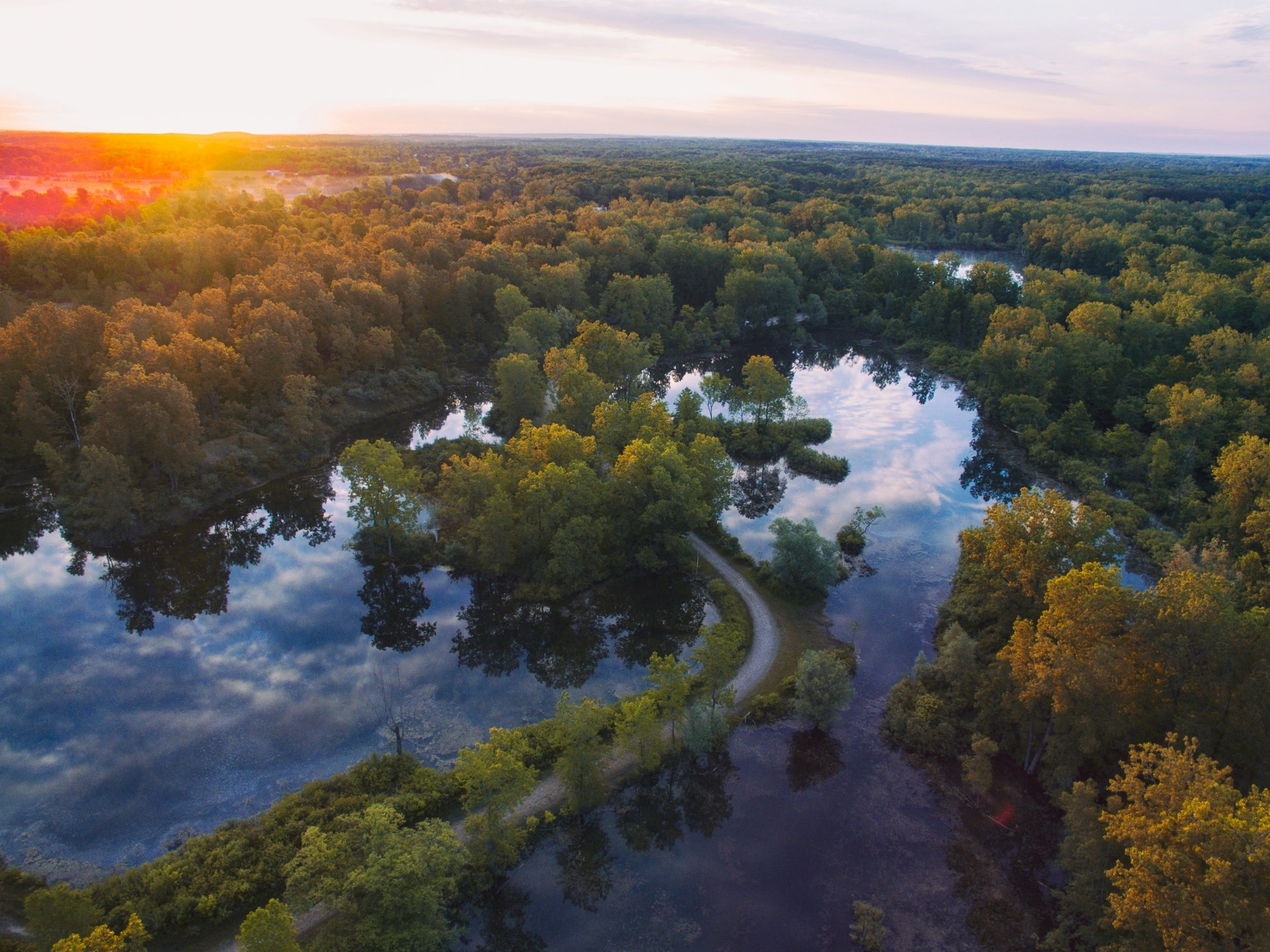 Otisville river road sunset from above in Michigan Image By aaron burden unsplash