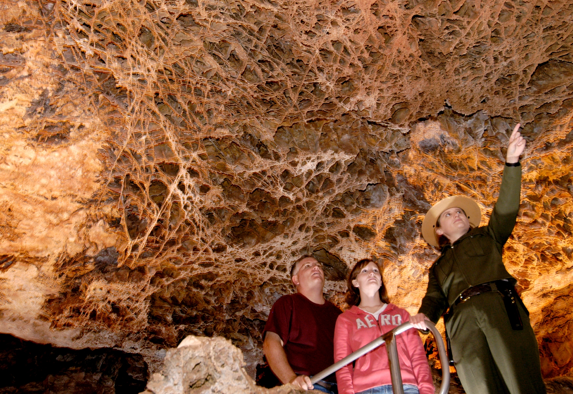 Guide pointing out cave formations at Wind Cave in Wind Cave National Park, South Dakota