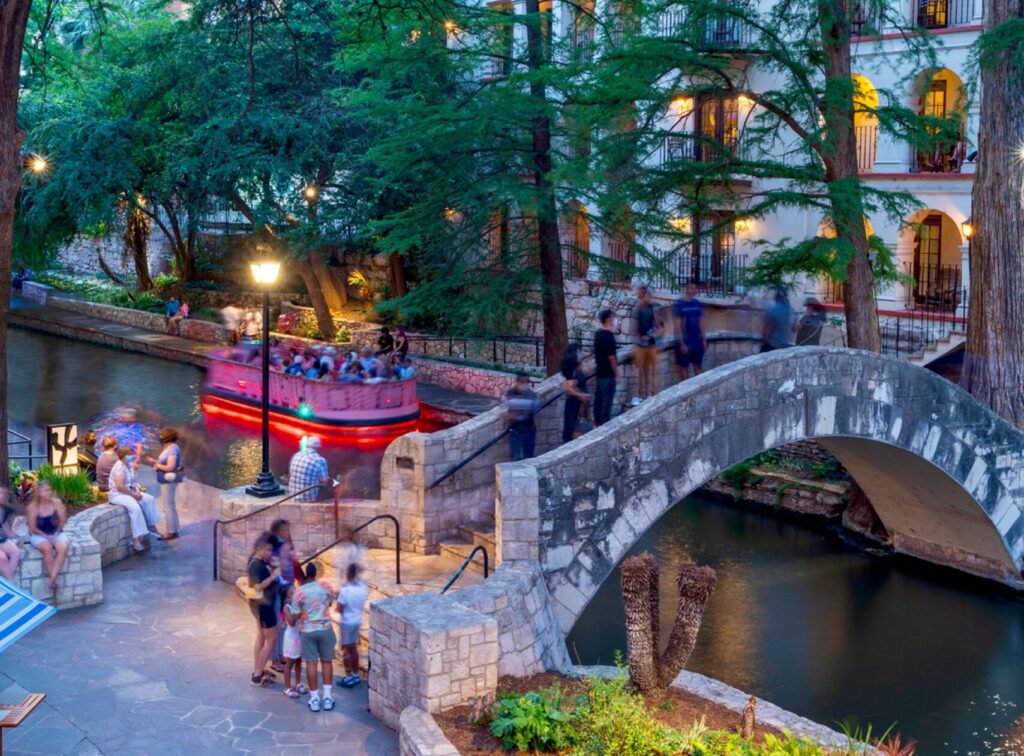 San Antonio River Walk Dining Barge and Bridge Image By Visit San Antonio Photo by Al Rendon Owns full rights scaled e1750645656328