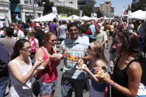 Taste of Buffalo Festival people enjoying a fest of Buffalo wings at a summer festival