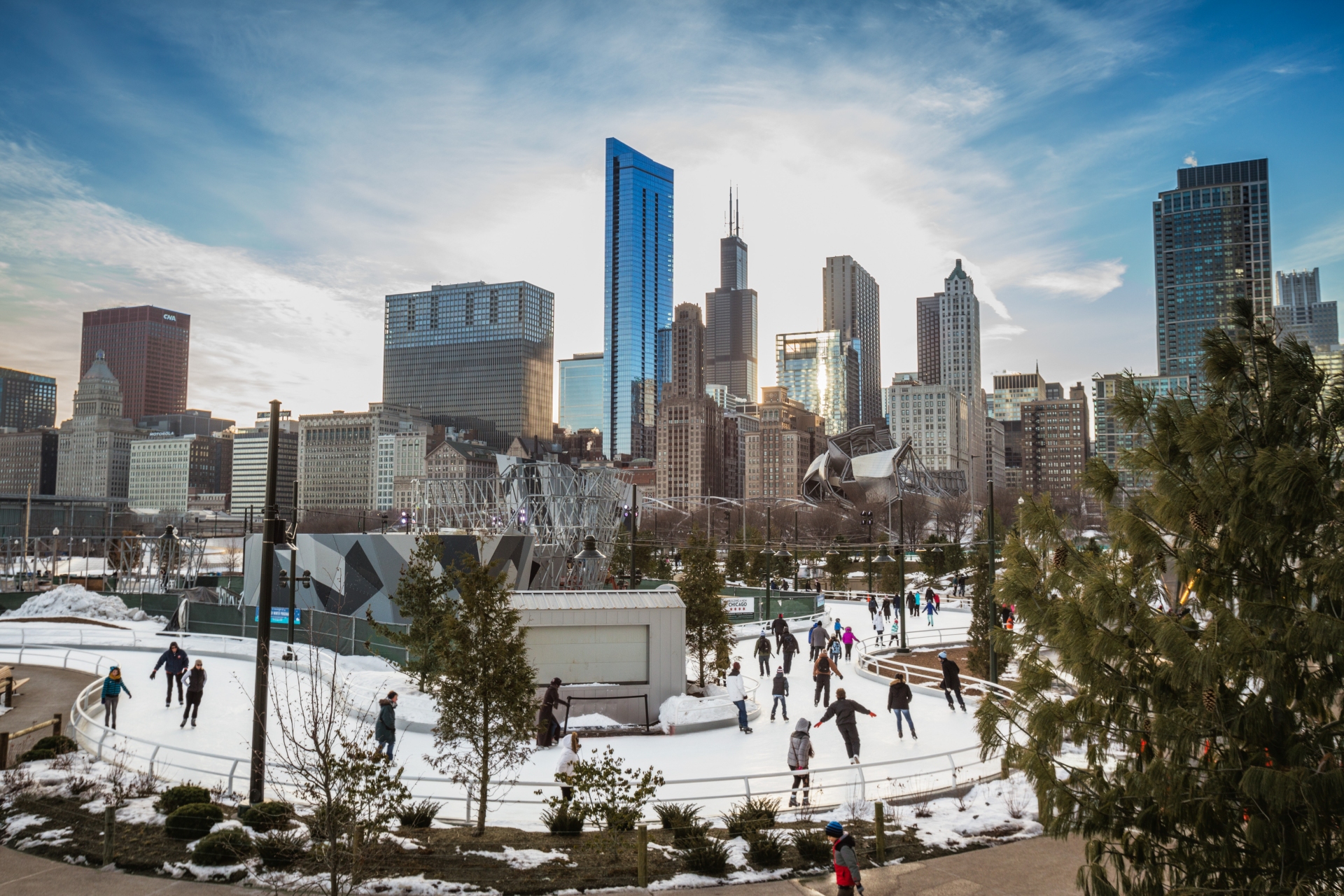 Wide shot of Chicago Skyline in winter Maggie Daley Park Ice Skating Ribbon Chicago IL Image By Ilinois Office of Tourism