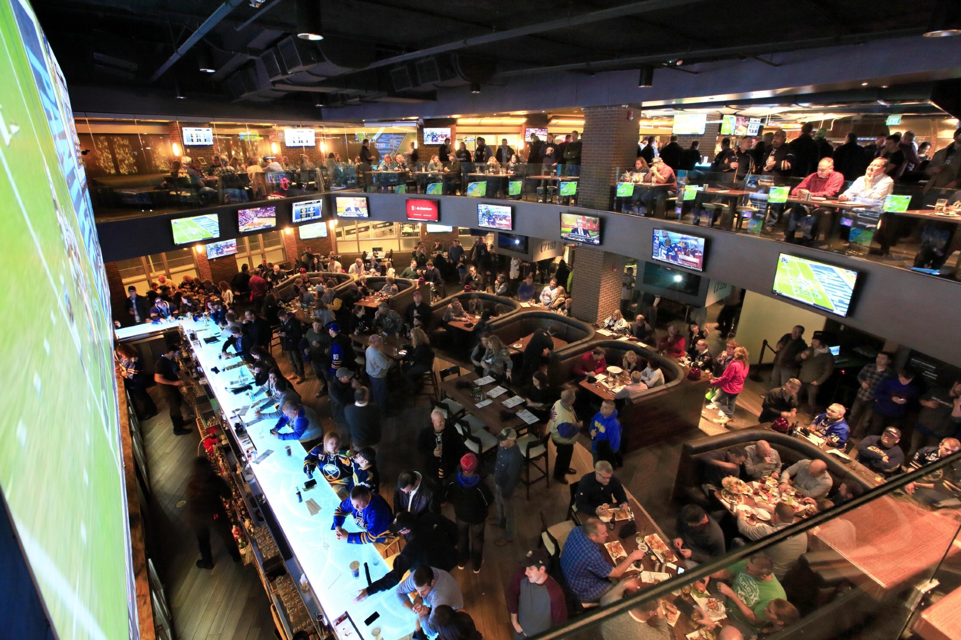 Food & Sport Venue in Buffalo NYS showing a packed bar with television set all around the bar