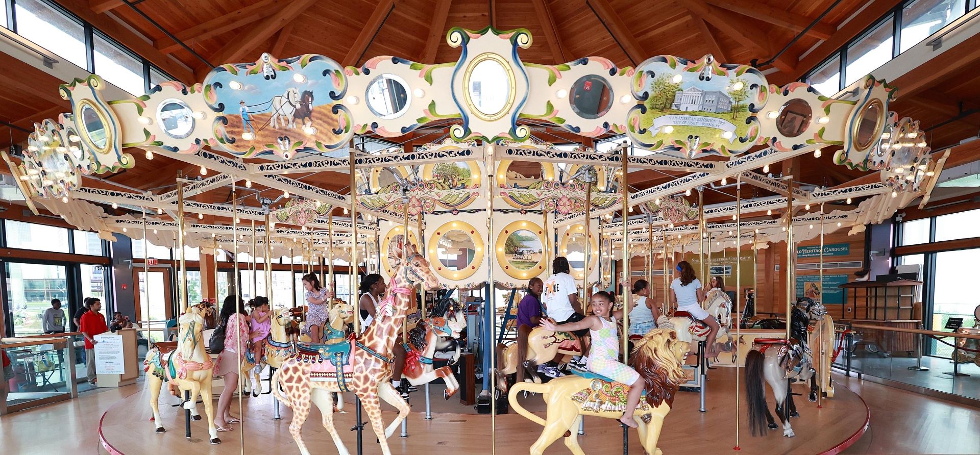 Heritage Carousel Canalside Buffalo NYS with children enjoying the ride on the animal carousel