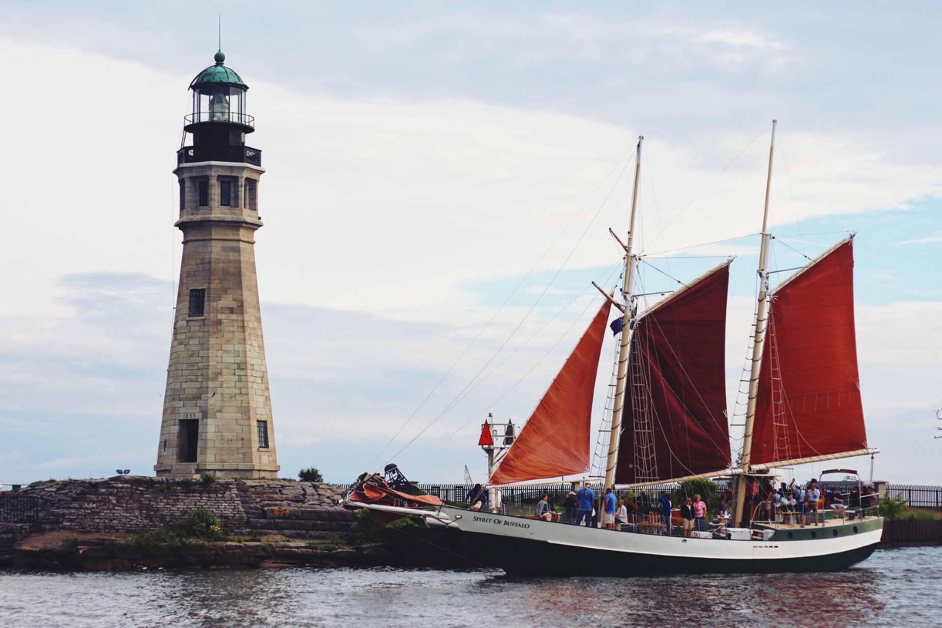 Spirit of Buffalo NYS showing the lighthouse with the Spirit of Buffalo Schooner sailing by